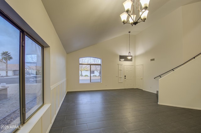 entryway with an inviting chandelier and high vaulted ceiling