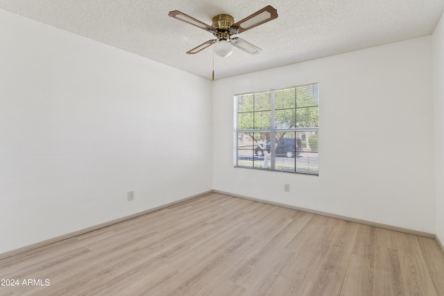 unfurnished room featuring baseboards, a textured ceiling, a ceiling fan, and wood finished floors