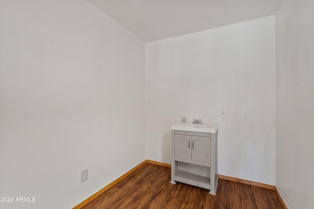 bathroom featuring vanity, baseboards, and wood finished floors