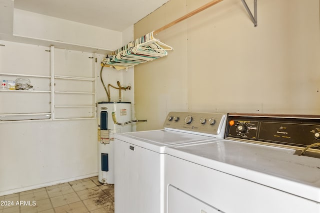 clothes washing area with washer and dryer, laundry area, and electric water heater