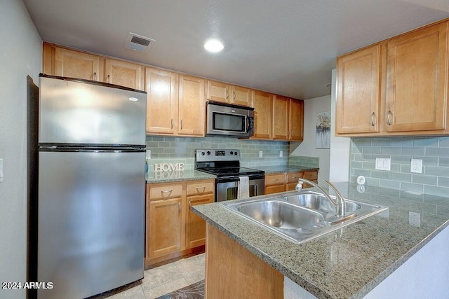 kitchen with kitchen peninsula, light tile patterned floors, backsplash, sink, and stainless steel appliances