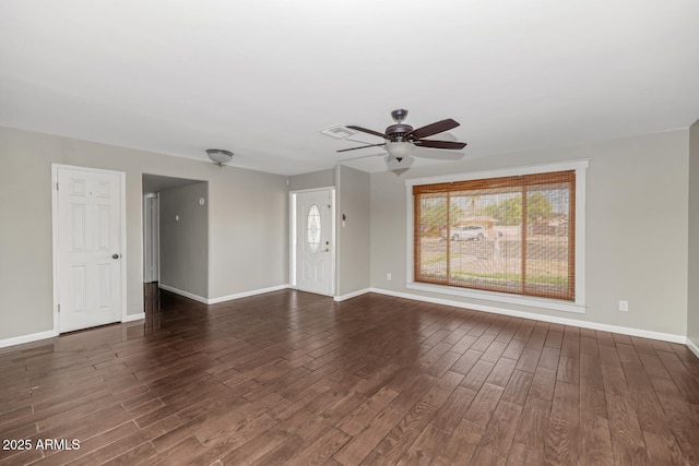 unfurnished living room featuring visible vents, baseboards, ceiling fan, and dark wood finished floors