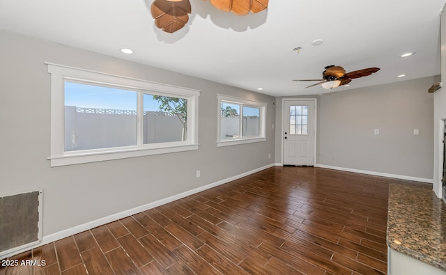 unfurnished living room featuring wood finished floors, ceiling fan, baseboards, and recessed lighting