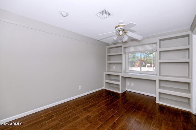 interior space featuring built in features, a ceiling fan, visible vents, dark wood-style flooring, and baseboards