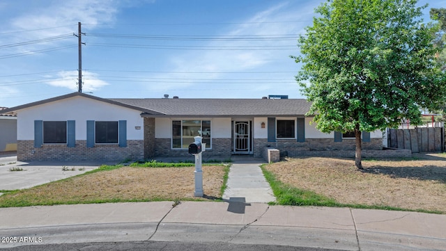ranch-style home with fence and brick siding
