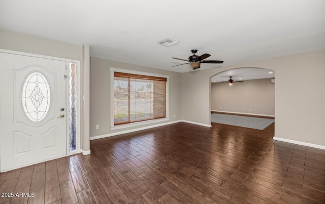 entryway with visible vents, baseboards, arched walkways, ceiling fan, and wood finished floors