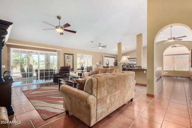 living room featuring ceiling fan, tile patterned floors, vaulted ceiling, and a wealth of natural light