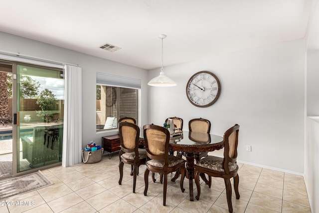 dining room with light tile patterned floors, baseboards, and visible vents