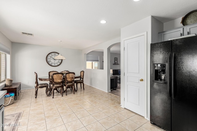 dining space featuring arched walkways, visible vents, recessed lighting, and light tile patterned floors