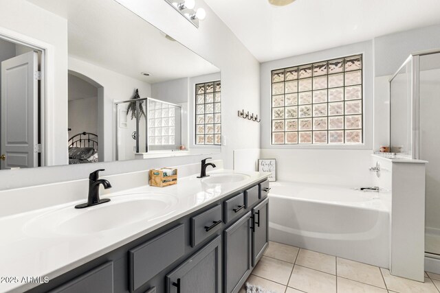 bathroom with a sink, a shower stall, a bath, and tile patterned floors