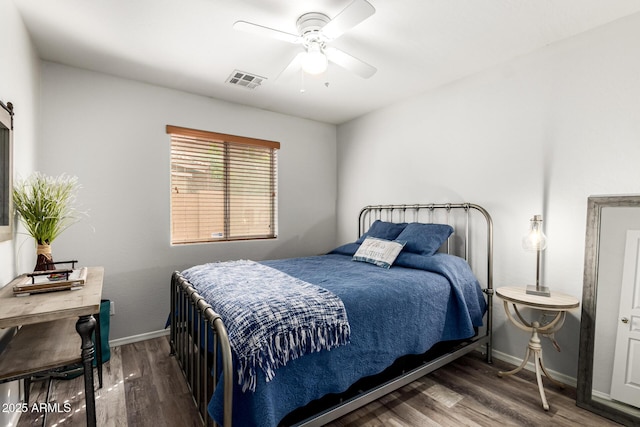 bedroom featuring visible vents, a ceiling fan, baseboards, and wood finished floors