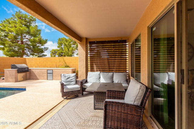 view of patio / terrace featuring an outdoor living space, area for grilling, and a fenced backyard