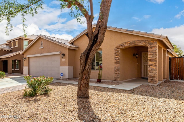 view of front of property featuring an attached garage, driveway, and stucco siding