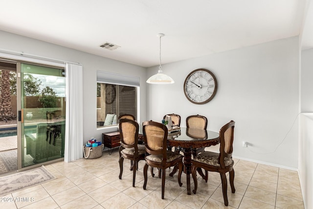 dining area with light tile patterned floors, baseboards, and visible vents