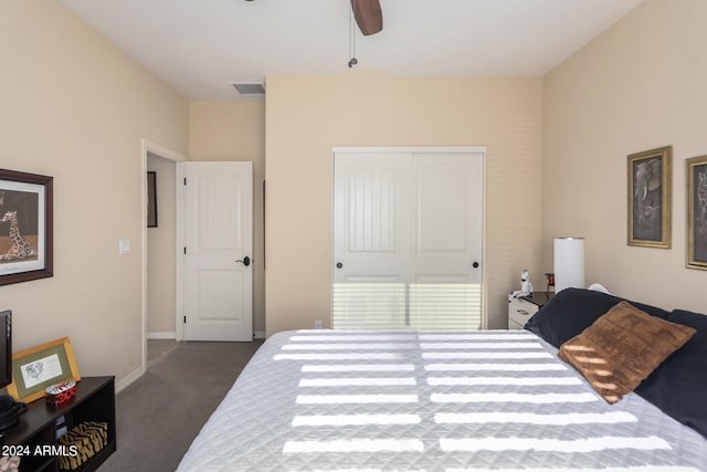 bedroom with a closet, ceiling fan, and dark carpet