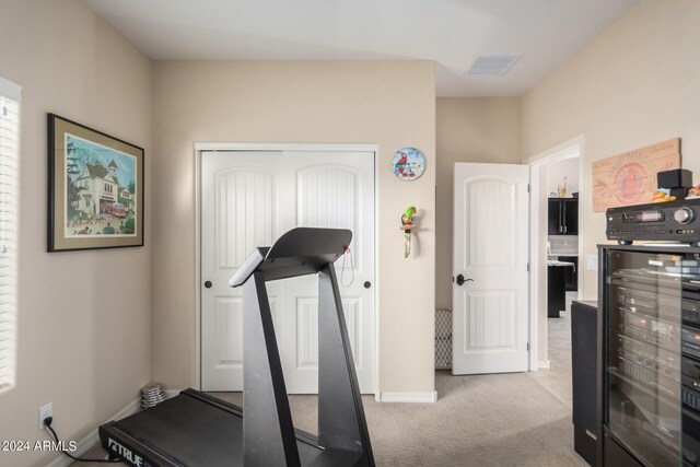 workout room with beverage cooler and carpet floors