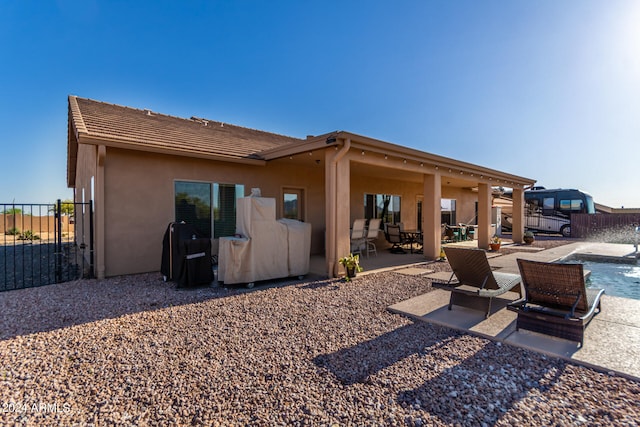 back of property featuring a patio