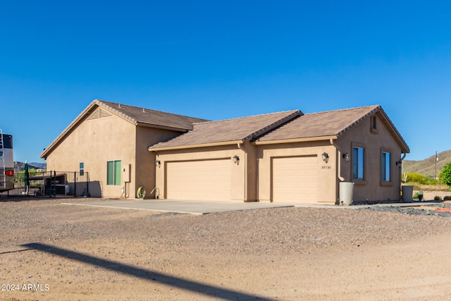 ranch-style house featuring a garage