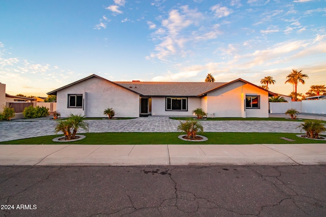 ranch-style home with a yard