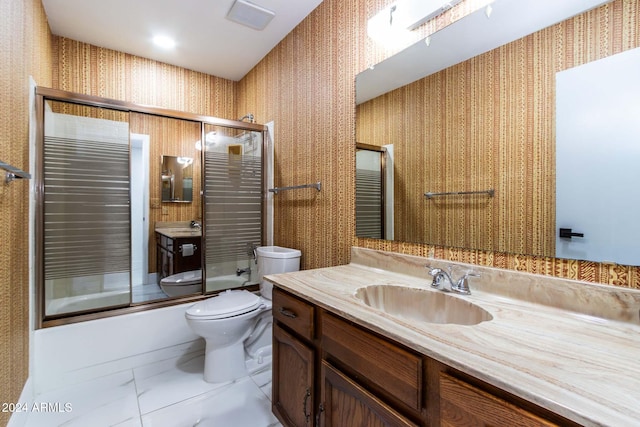 full bathroom with toilet, bath / shower combo with glass door, vanity, and tile patterned flooring