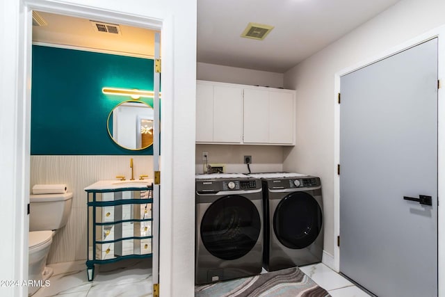 clothes washing area featuring sink and washer and clothes dryer