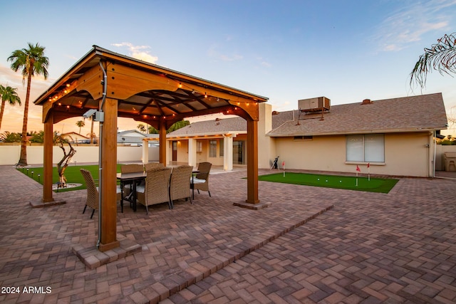 patio terrace at dusk featuring a gazebo