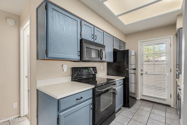 kitchen featuring black appliances and light tile patterned flooring