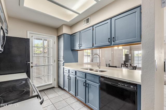 kitchen featuring blue cabinetry, sink, black appliances, and light tile patterned flooring