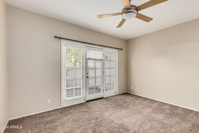 carpeted empty room with ceiling fan