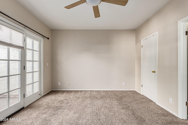 empty room with light colored carpet and ceiling fan