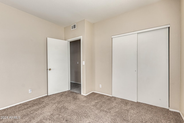 unfurnished bedroom with a closet and carpet