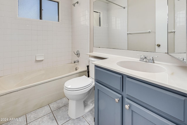 full bathroom featuring vanity, tile patterned floors, toilet, and tiled shower / bath combo