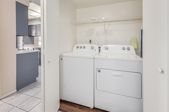 laundry room featuring light hardwood / wood-style flooring and washing machine and dryer