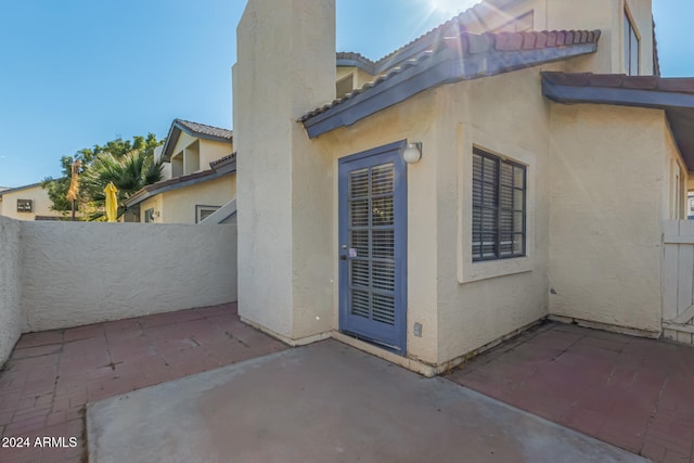 view of side of home featuring a patio area