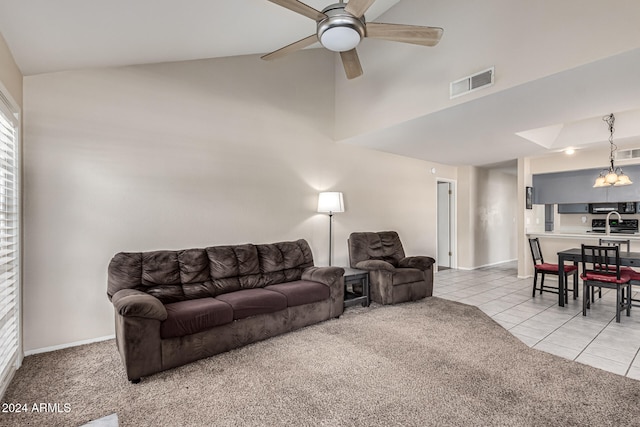 carpeted living room featuring ceiling fan, sink, and high vaulted ceiling