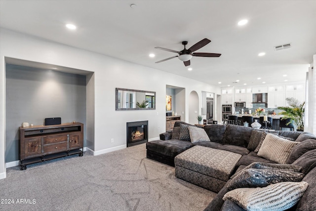 carpeted living room featuring ceiling fan