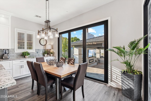 dining room with an inviting chandelier and dark wood-type flooring