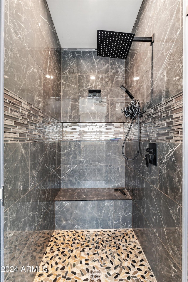 bathroom with a tile shower