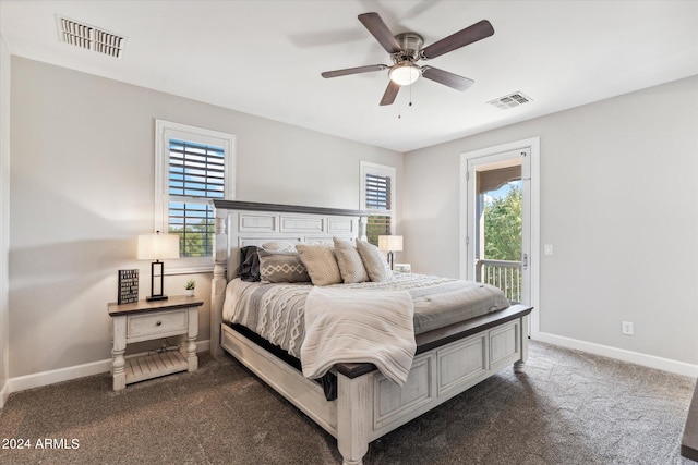 bedroom with multiple windows, ceiling fan, dark carpet, and access to outside