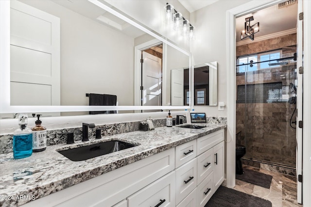 bathroom with ornamental molding, vanity, toilet, and an enclosed shower