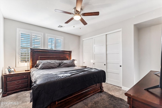 carpeted bedroom with a closet and ceiling fan