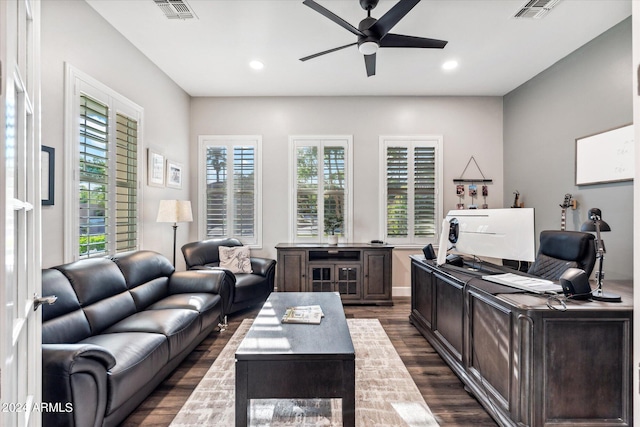 home office with dark hardwood / wood-style flooring and ceiling fan