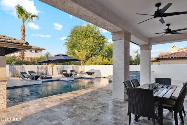 exterior space with ceiling fan, a patio, and pool water feature