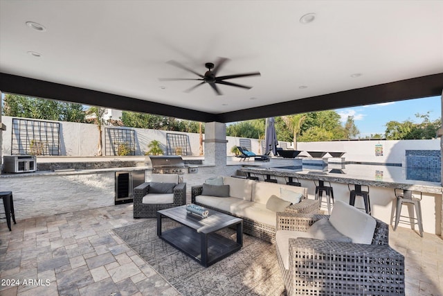 view of patio with grilling area, an outdoor kitchen, and ceiling fan