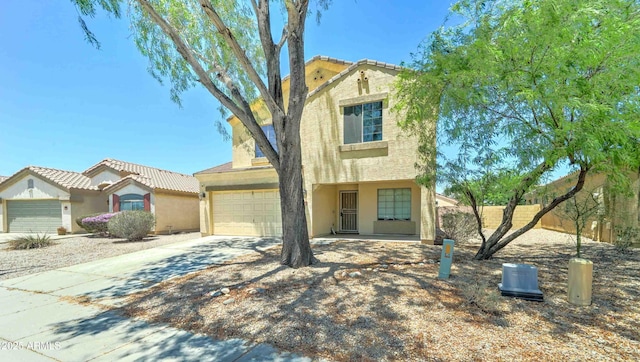 10524 W Pima St, Tolleson, AZ 85353 - view of front of home with stucco siding, driveway, and an attached garage