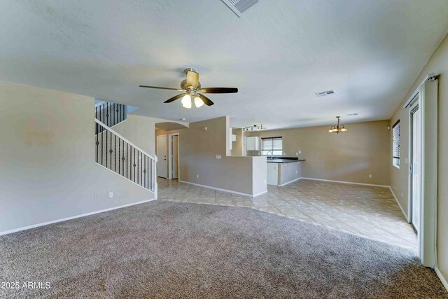 10524 W Pima St, Tolleson, AZ 85353 - unfurnished living room with light colored carpet, arched walkways, a chandelier, a ceiling fan, and stairway