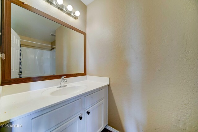 10524 W Pima St, Tolleson, AZ 85353 - full bath with vanity, a textured wall, and a shower