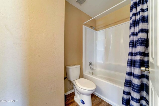 10524 W Pima St, Tolleson, AZ 85353 - bathroom with shower / bath combo with shower curtain, a textured wall, and wood finished floors
