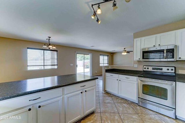 10524 W Pima St, Tolleson, AZ 85353 - kitchen with stainless steel appliances, white cabinetry, dark countertops, and a chandelier
