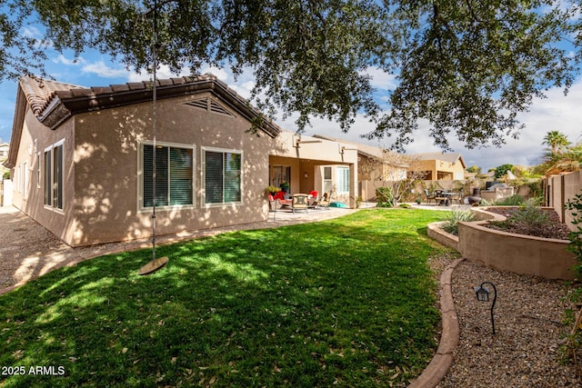 back of property featuring a yard and a patio area